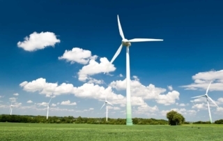 Wind turbines in the field, how big tech is leading the way in clean energy.