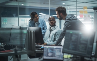 A group of professionals working cyber security jobs in a modern office.