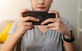 A woman is playing Wordle on her smartphone.